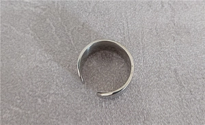 Close-up of vintage punk eagle feather open ring in polished silver titanium steel