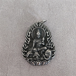 Vintage stainless steel Guanyin pendant with relief carving on grey felt background