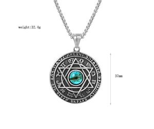 Detailed macro view of silver steel medallion pendant featuring emerald gem and hexagram