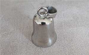 Close-up of a silver stainless steel bell pendant with polished finish and metal clasp