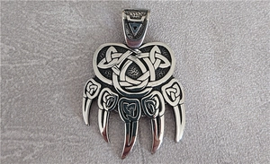 Macro detail of Nordic Viking bear paw pendant in vintage silver stainless steel
