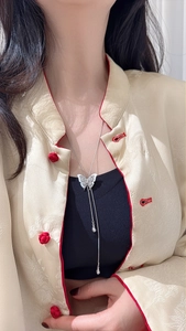 Detail of S925 silver butterfly tassel necklace with adjustable long chain on a model
