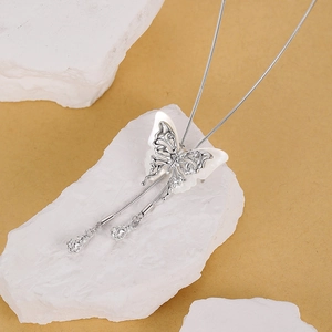 Elegant S925 silver butterfly tassel necklace with shell inlay on white stone pedestal