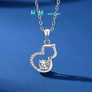 Macro shot of S925 silver gourd pendant with pavé diamonds and a round center stone