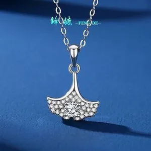 Macro shot of S925 silver ginkgo leaf pendant with sparkling pave-set moissanite stones