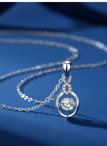 Macro shot of S925 sterling silver necklace with a dancing moissanite pendant