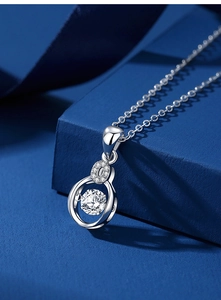 Macro detail of s925 silver moissanite heart pendant with brilliant stone on blue silk