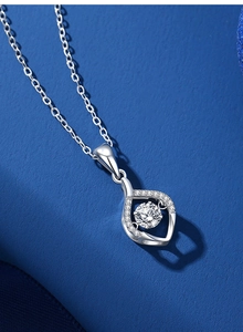 Macro shot of S925 silver teardrop pendant with dancing moissanite and pave stones