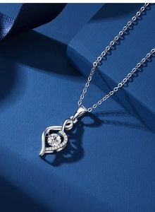 Close-up of S925 sterling silver heart pendant with shimmering center stone and fine chain