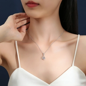 Sparkling S925 sterling silver necklace with moving heart stone on an Asian woman