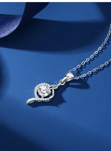 Macro detail of S925 silver heart spiral pendant with 1ct moissanite on silk background