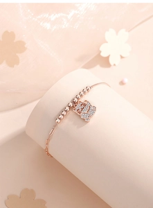 Detailed close-up of a rose gold Lucky Cat bracelet featuring sparkling pavé crystals