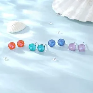 Macro detail of S925 silver stud earrings with colorful round cut cubic zirconia stones