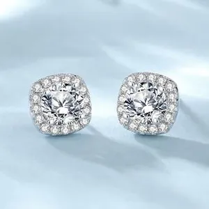 Macro view of S925 silver halo earrings with round cut center stone and pavé accents