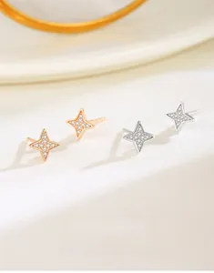 Macro shot of S925 silver four-pointed star earrings in silver and rose gold finishes