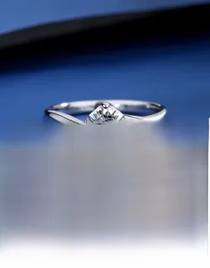 Detailed macro shot of a Moissanite gemstone set in a classic S925 silver six-prong ring