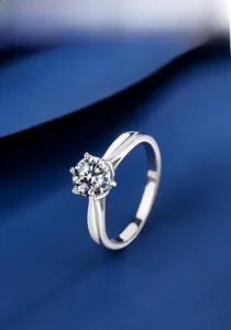 Detailed close-up of a 1-carat moissanite ring with classic six-prong silver setting