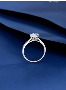 Macro shot of 925 silver six-prong setting with a brilliant round-cut moissanite stone
