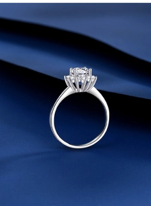 Macro shot of a 1 carat moissanite halo ring with classic six-prong setting on silver band