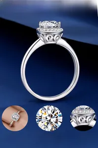 Detail view of silver ring featuring heart cutout patterns and brilliant moissanite stone