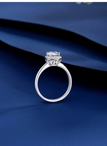 Macro detail of a 1ct moissanite ring with halo setting and intricate silver filigree work