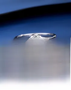 Macro shot of S925 silver moissanite ring with six-prong setting and twisted band