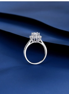 Macro side view of a S925 silver moissanite ring with six-prong setting and halo design