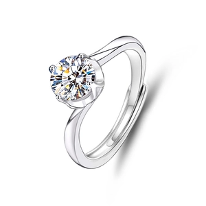 Macro view of adjustable silver ring featuring a classic four-prong moissanite setting