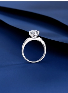 Macro shot of silver crown-shaped ring with 1ct moissanite and side diamond accents