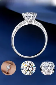 Macro shot of 925 silver six-prong moissanite ring with side stones on silk fabric