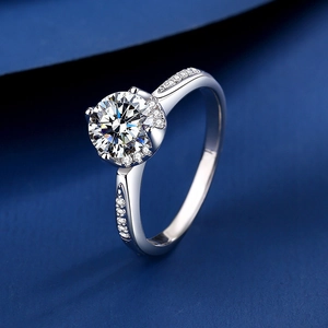 Elegant 925 sterling silver crown ring with 1 carat moissanite on blue velvet background