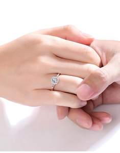 Detailed view of square moissanite engagement ring with twisted pavé band on finger