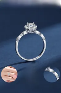 Detail view of silver Moissanite ring featuring six-prong setting and polished plating