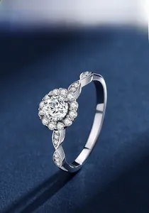 Macro shot of silver Halo ring with Moissanite stone and vintage leaf pattern band