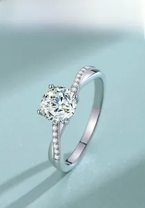 Close-up of S925 silver moissanite ring with twisted pavé band and four-prong setting