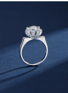 Macro shot of silver crown ring with large round moissanite and pave diamond setting