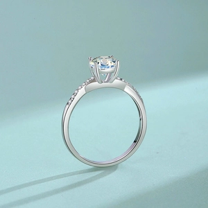 S925 sterling silver moissanite engagement ring with four-prong setting and pavé band