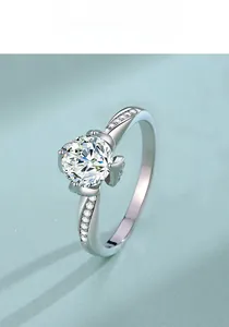 Macro shot of silver lotus-inspired moissanite ring with pave diamond details on band
