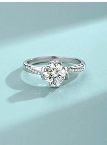 Macro shot of S925 silver lotus ring with moissanite center stone and side diamonds