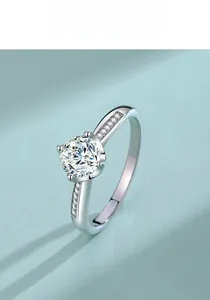 Close-up of a classic six-prong moissanite ring with side accent diamonds in S925 silver
