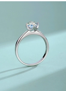 Detailed view of 925 silver six-prong crown moissanite ring with side-pave accents