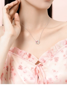 Model wearing silver butterfly wreath necklace with pink gemstone and zircon accents