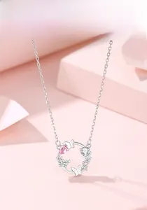 Detail of S925 silver wreath necklace featuring pink butterfly pendant and zircon stones
