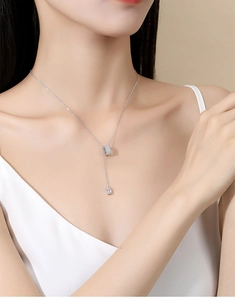 Macro shot of S925 sterling silver tassel necklace with pave crystals and rectangle drop