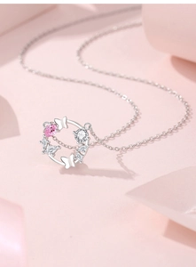 Macro shot of S925 silver butterfly wreath pendant with pink teardrop zirconia stone