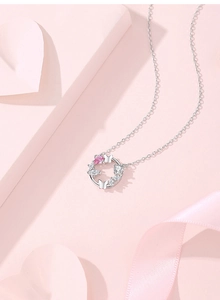 Macro detail of S925 silver butterfly wreath necklace with pink teardrop gemstone