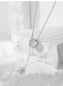 Macro shot of S925 silver Y-shaped necklace with micro-pave cylinder and rectangle gem