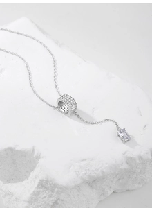 Detail of S925 silver cylinder pendant with cubic zirconia and rectangular stone
