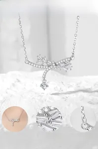 Macro detail of S925 silver bow necklace with cubic zirconia and hand polished finish