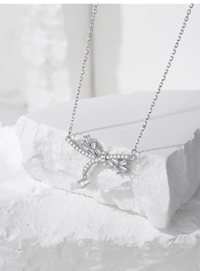 Close-up of S925 silver dragonfly necklace with sparkling cubic zirconia on stone
